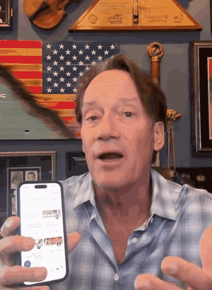 Kevin Sorbo holding his phone with the ActsSocial app on screen